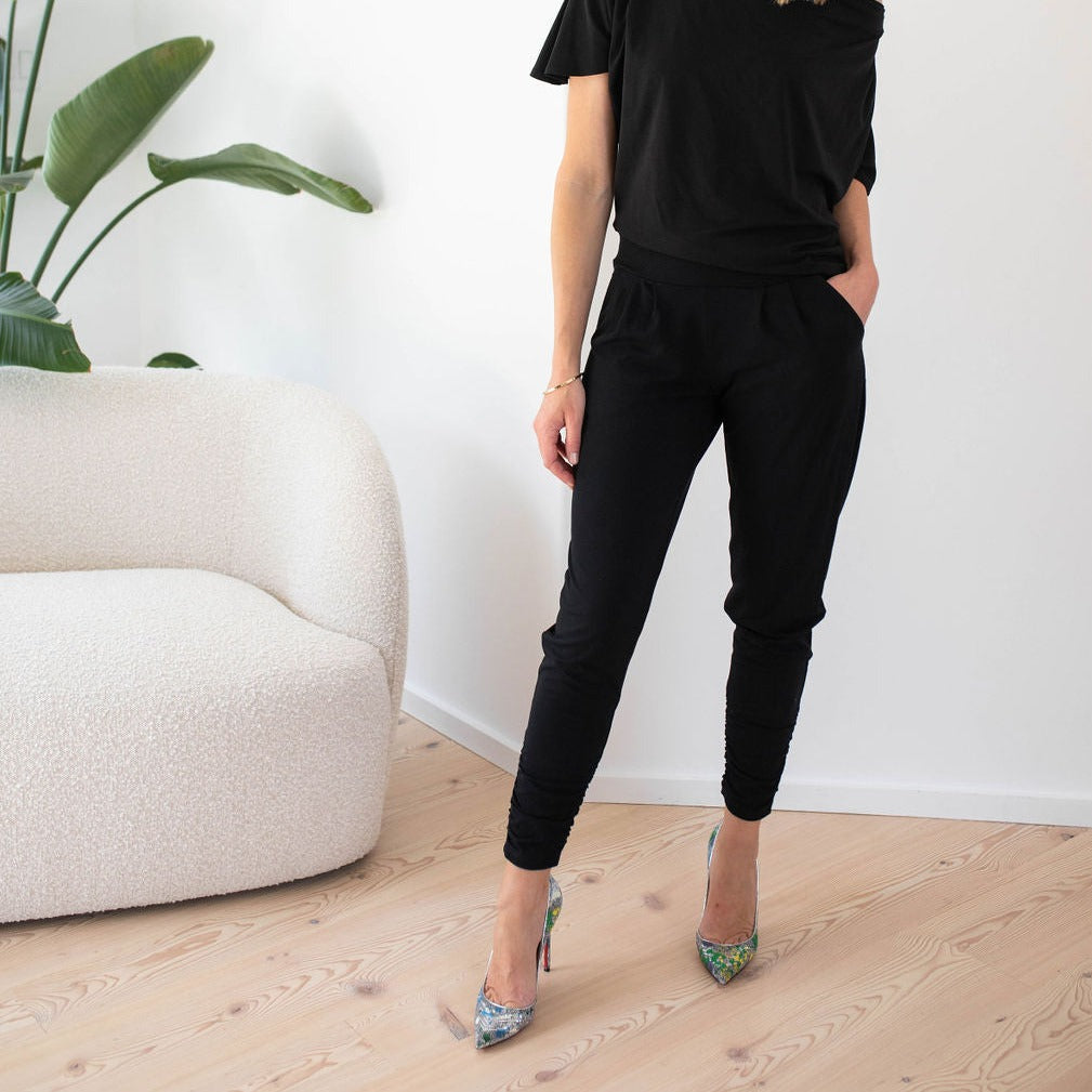 woman wearing black sweatpants with a black top