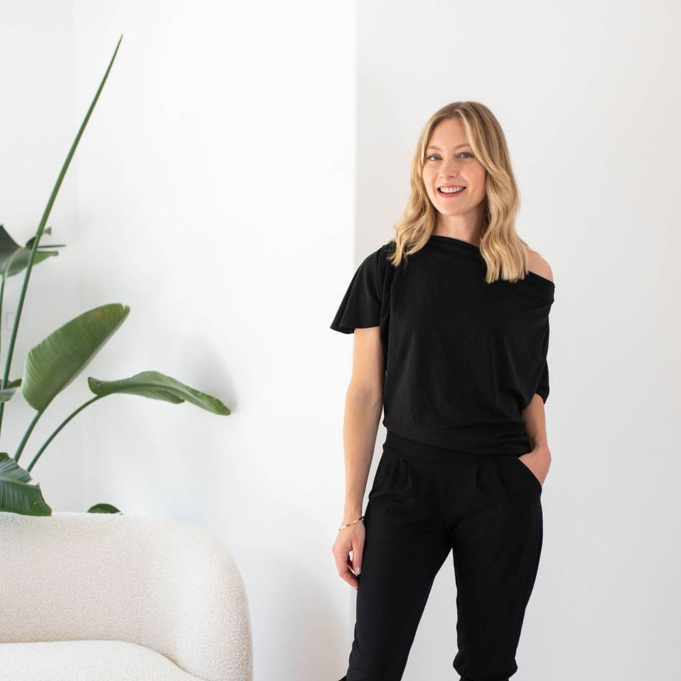 woman wearing one shoulder black dress top