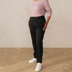woman wearing a dark grey tailored pants with white sneakers