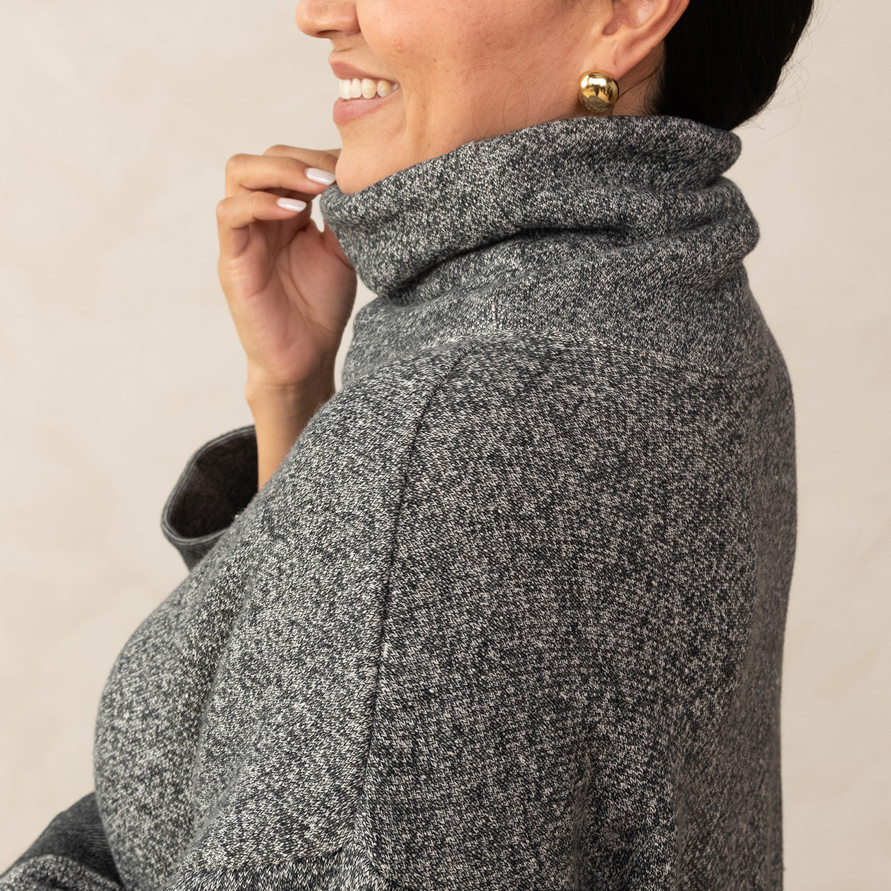 close up on a high neck heathered grey high neck sweater