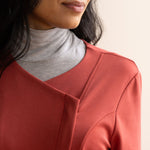 Neckline detail of brick colour jacket