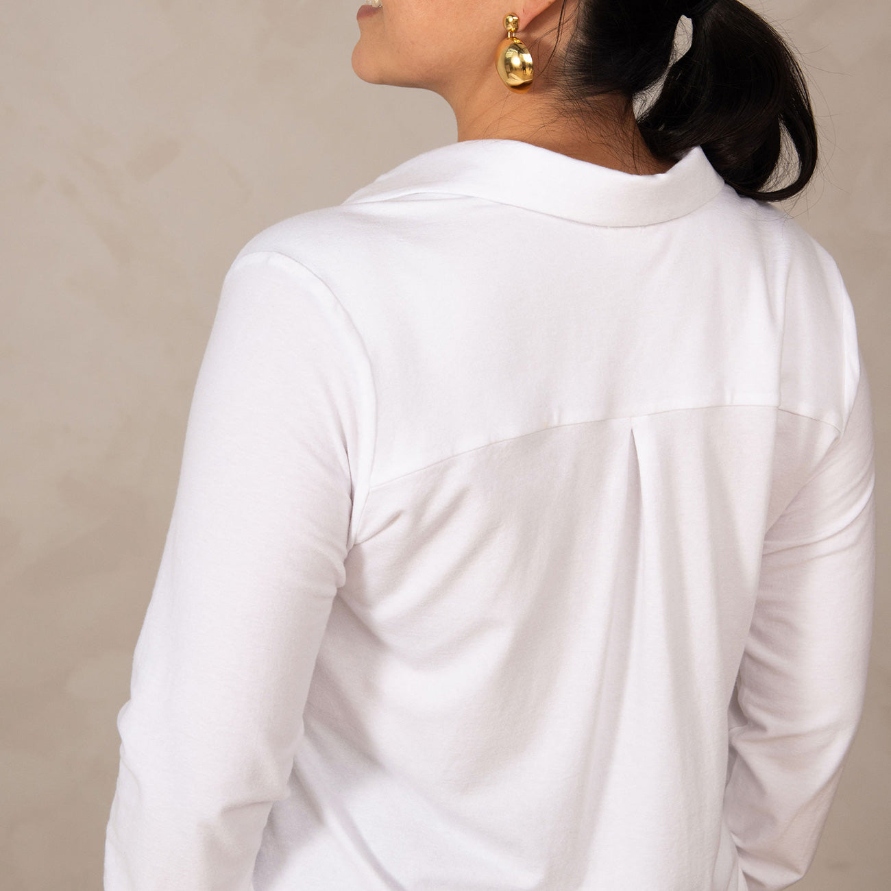 woman wearing a white button-up shirt