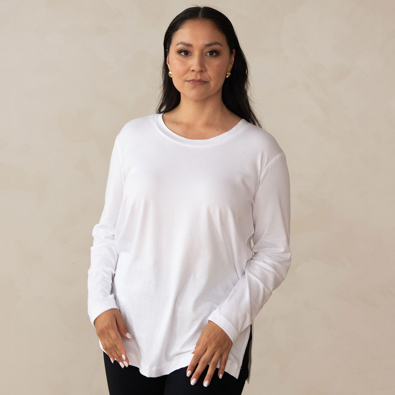 woman wearing a long sleeve scoop neck white top