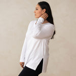 woman wearing a long sleeve scoop neck white top