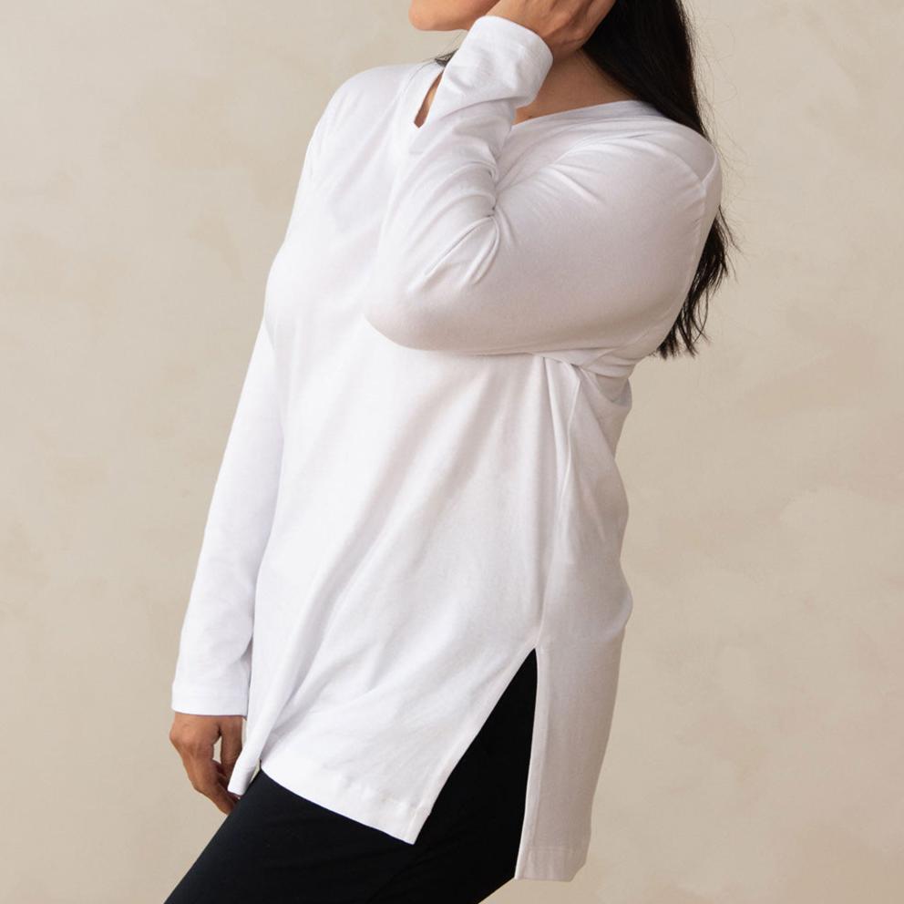 woman wearing a long sleeve scoop neck white top