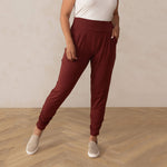 Woman wearing red sweatpants with white top