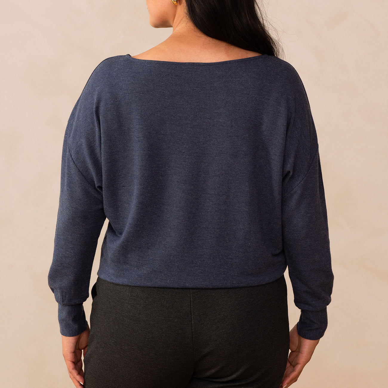 woman wearing a navy long sleeve sweatshirt