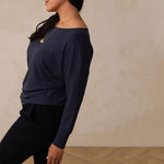 woman wearing a navy long sleeve sweatshirt