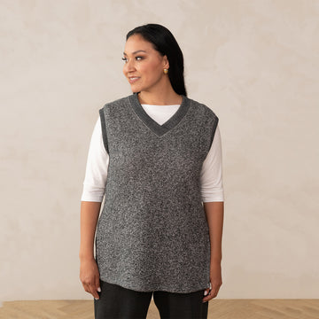 woman wearing a heirloom grey vest and a boat neck white top