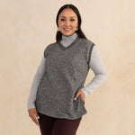 woman wearing a heirloom grey vest and a light grey turtleneck