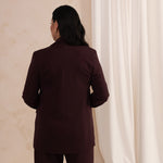 back of a woman wearing an aubergine blazer