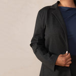 close up of grey blazer on top os a navy top