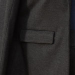 close up of pocket of a grey blazer