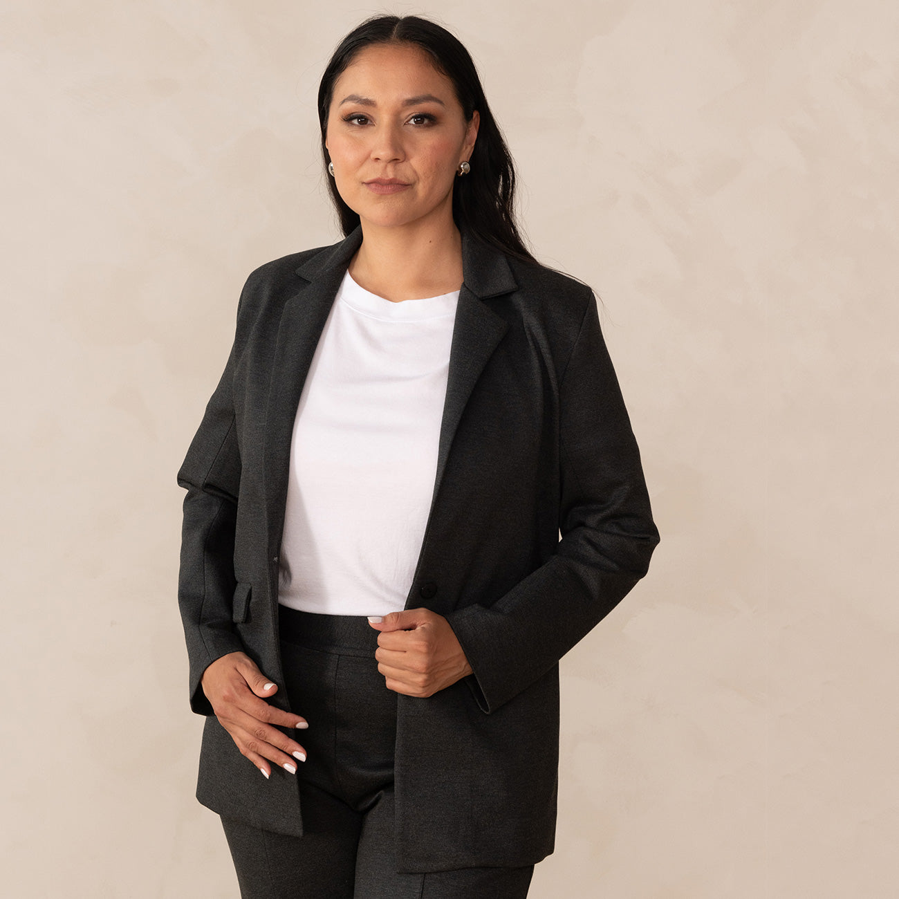 woman wearing a grey blazer on top of a white t-shirt