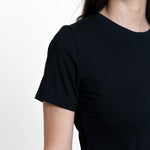 Woman wearing loose black crew neck t-shirt 