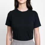 Woman wearing loose black crew neck t-shirt