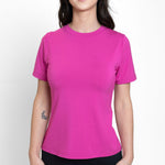 Woman wearing loose bright pink crew neck t-shirt