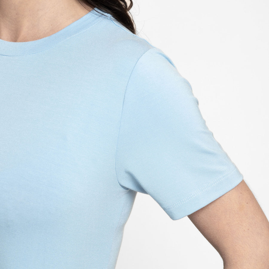 Woman wearing loose light blue crew neck t-shirt