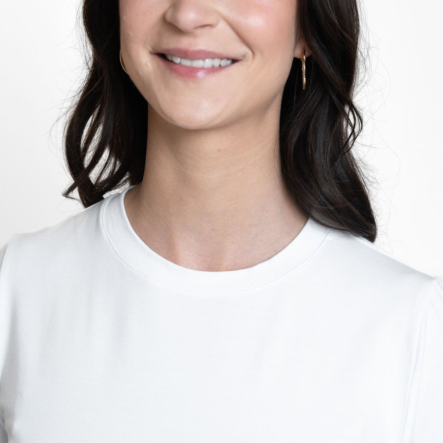 Woman wearing loose white crew neck t-shirt