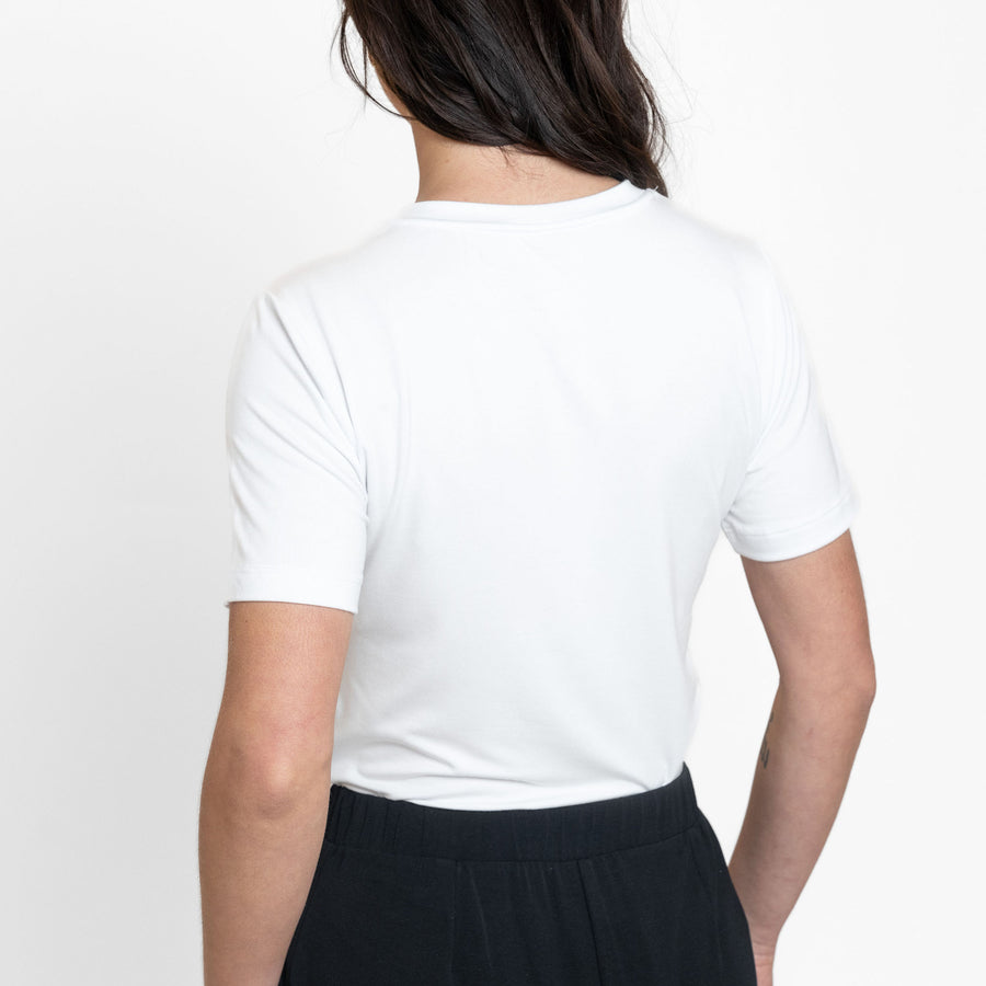 Woman wearing loose white crew neck t-shirt and loose black stretchy wide leg pants