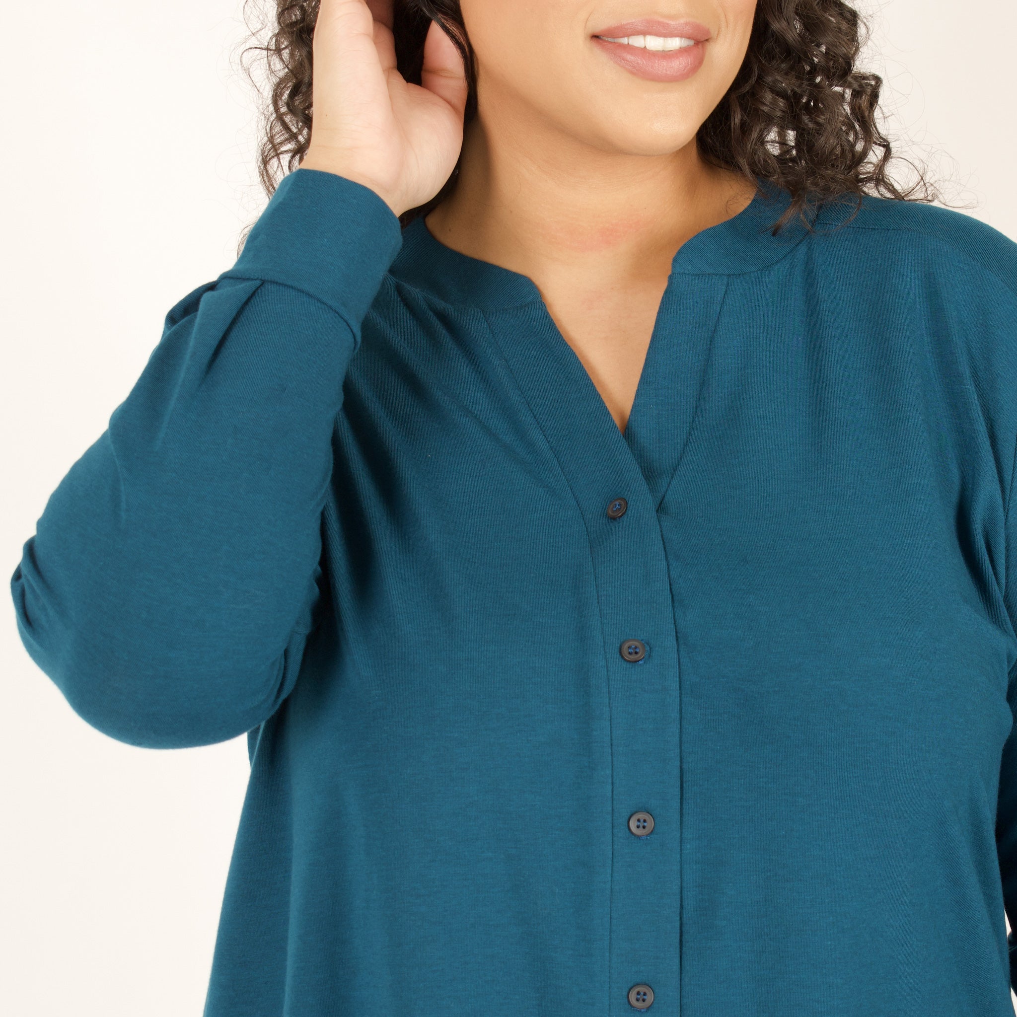 Woman wearing bright blue long sleeve button up shirt