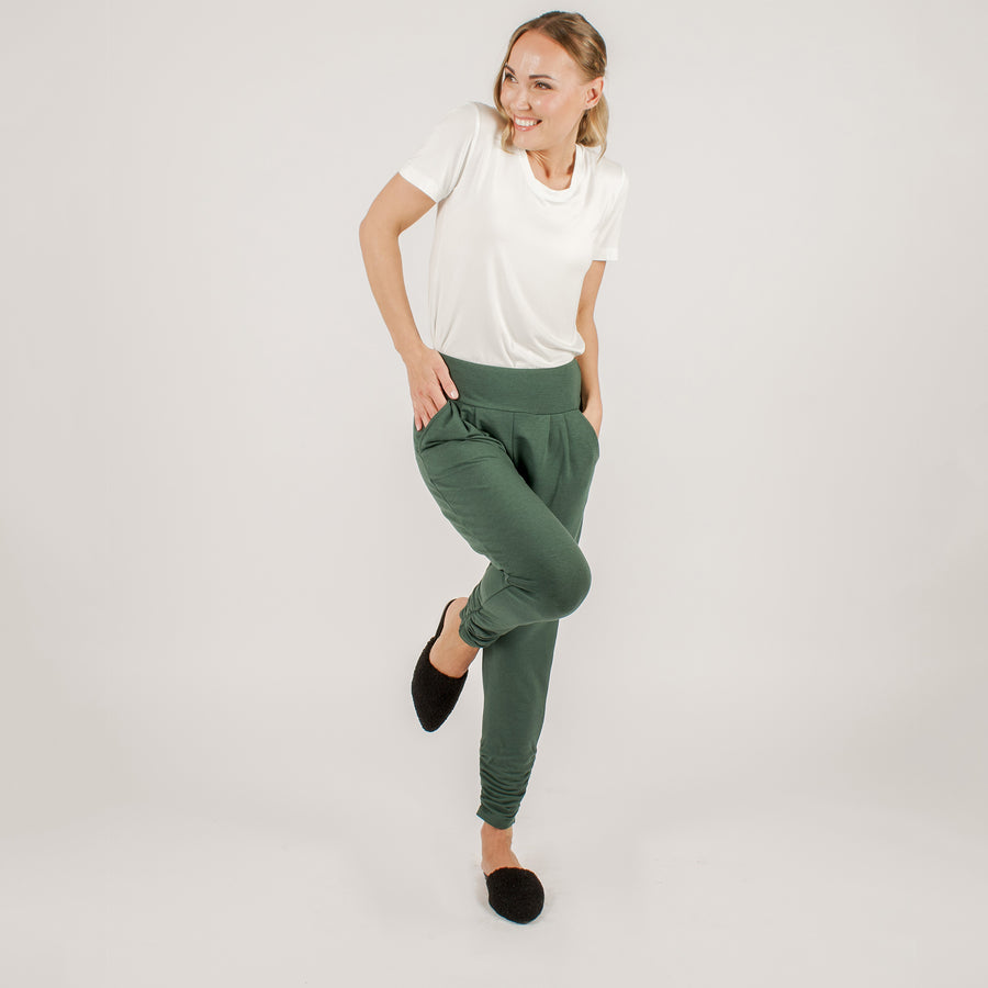 Woman wearing navy stretchy sweatpants with white shirt