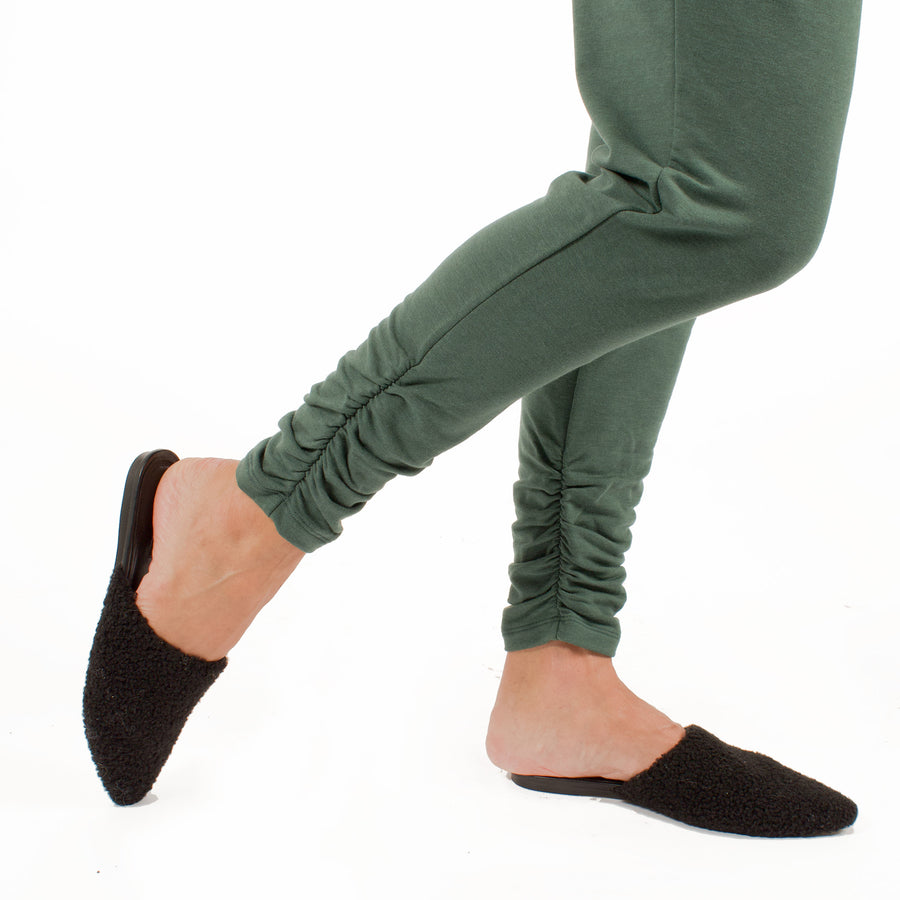 Woman wearing green stretchy sweatpants