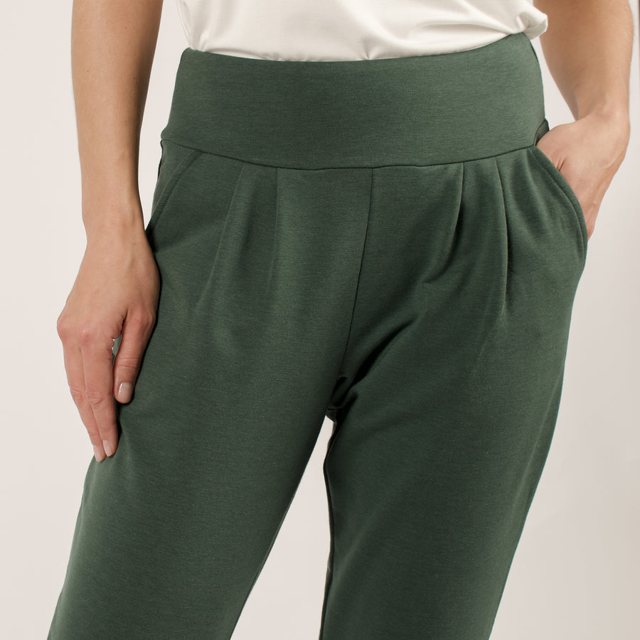 Woman wearing green stretchy sweatpants