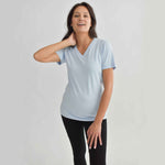 Woman wearing light blue v-neckline t-shirt with black fitted leggings