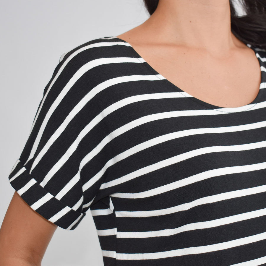 Woman wearing loose horizontal black and white striped short sleeve knee length dress with pockets
