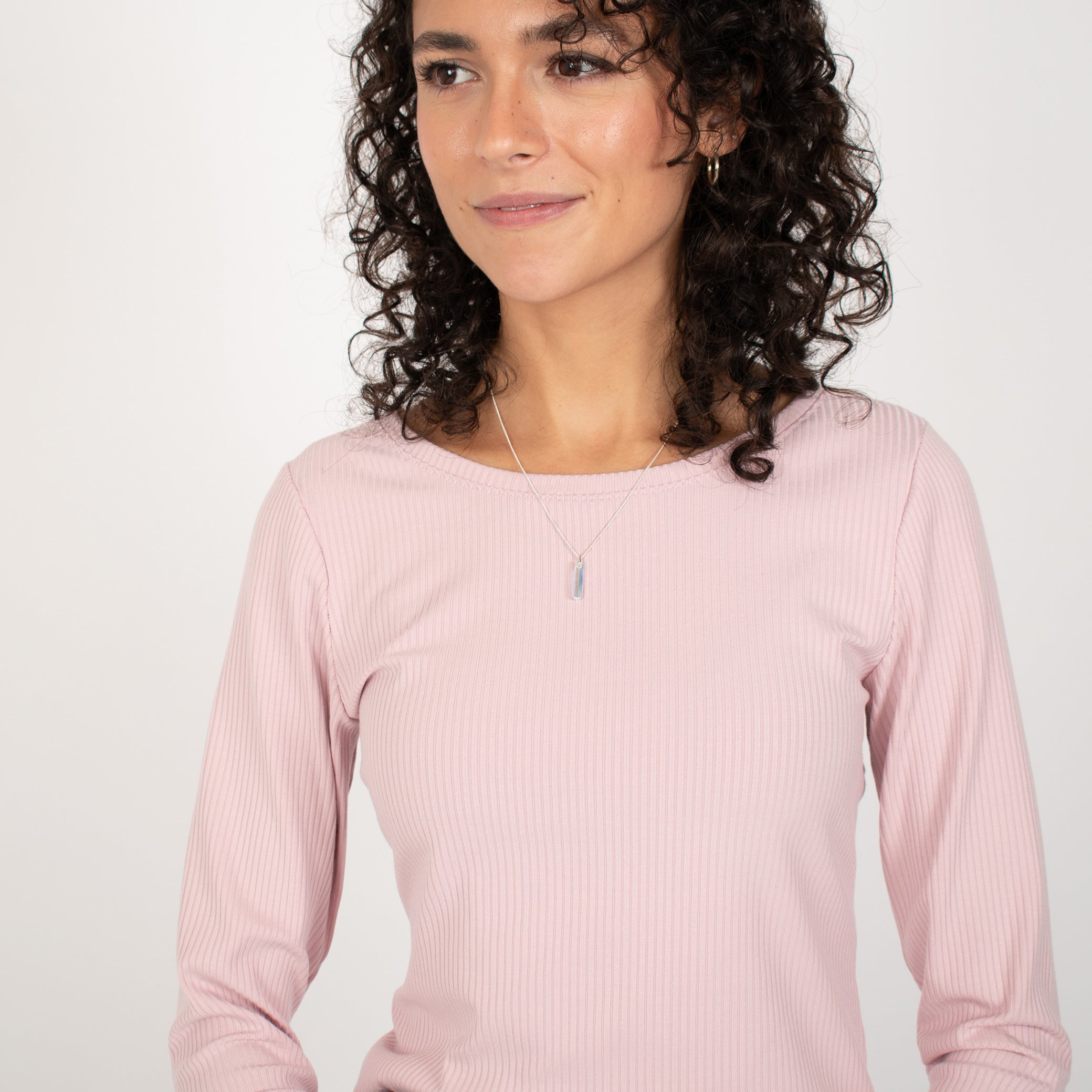 Woman wearing light pink rib knit reversible long sleeve top