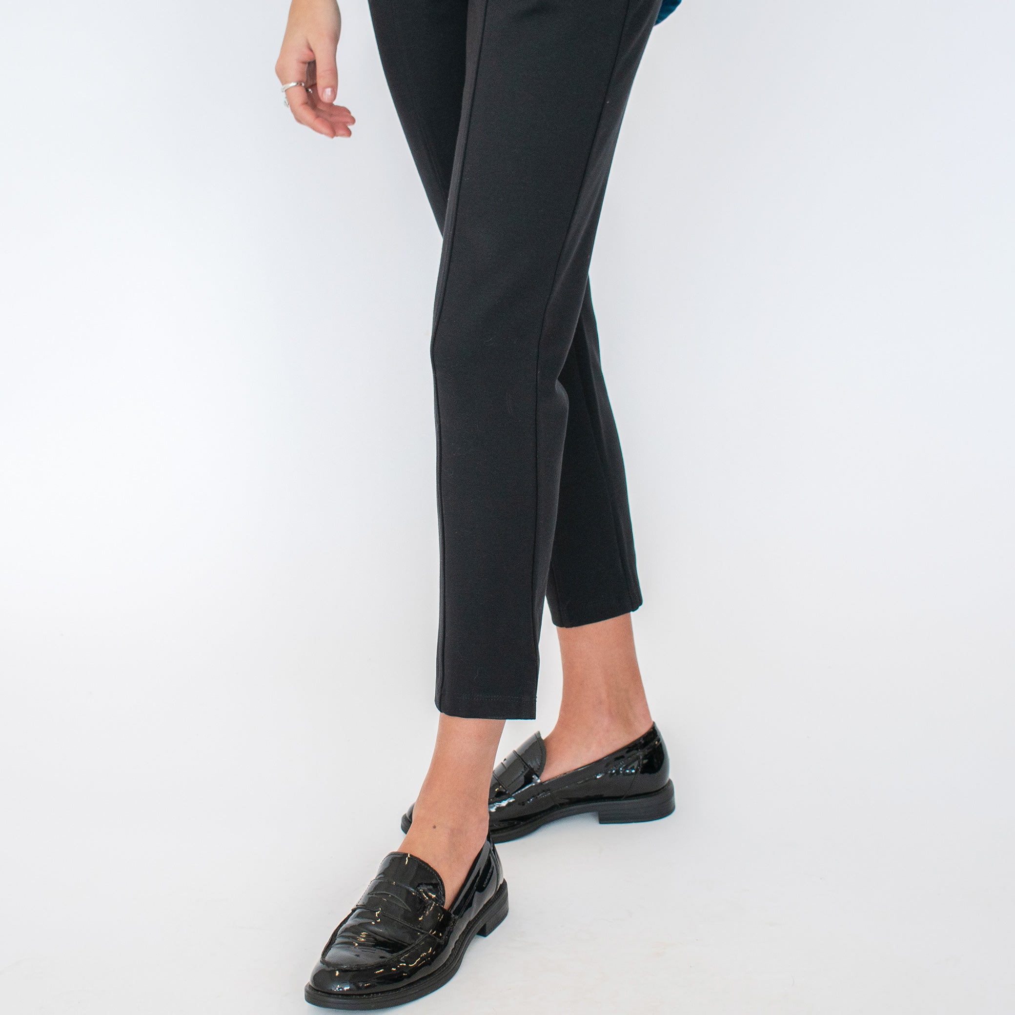 Woman wearing black tailored stretchy ankle length pants