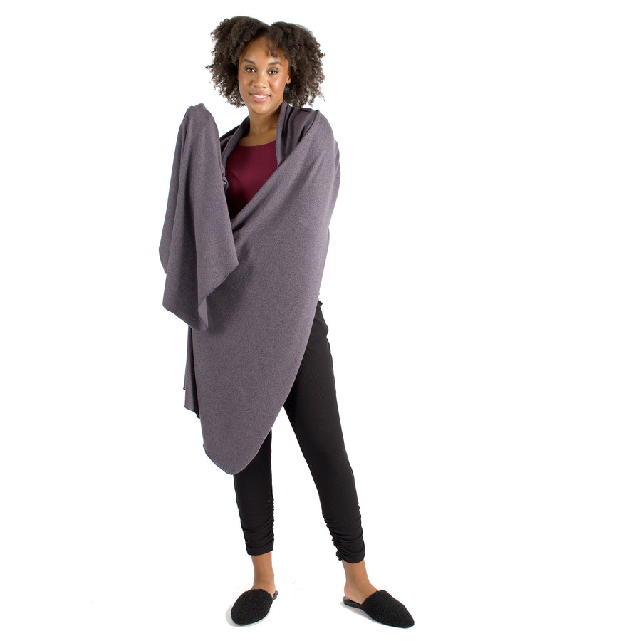 Woman wearing light grey wrap-up scarf around their upper body with maroon long sleeve shirt and black pants