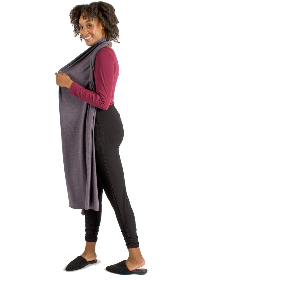 Woman wearing light grey wrap-up scarf around their neck body with maroon long sleeve shirt and black pants