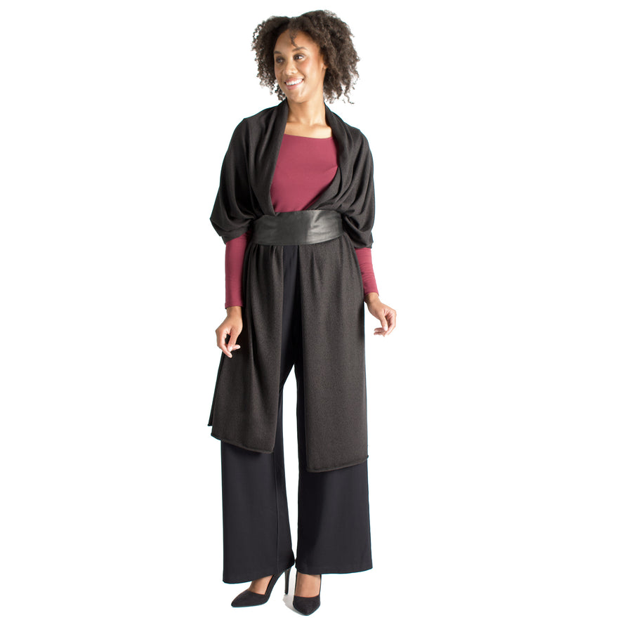 Woman wearing black wrap-up scarf around their shoulders with maroon long sleeve shirt and black flowing pants