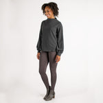 Woman wearing fitted light brown high-rise waist with ankle length leggings featuring seamless stitching and a hidden back pocket 